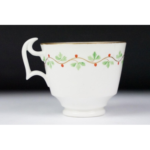 29 - Swansea pottery cup and saucer, hand painted with a floral garland, the saucer, 13.5cm diameter