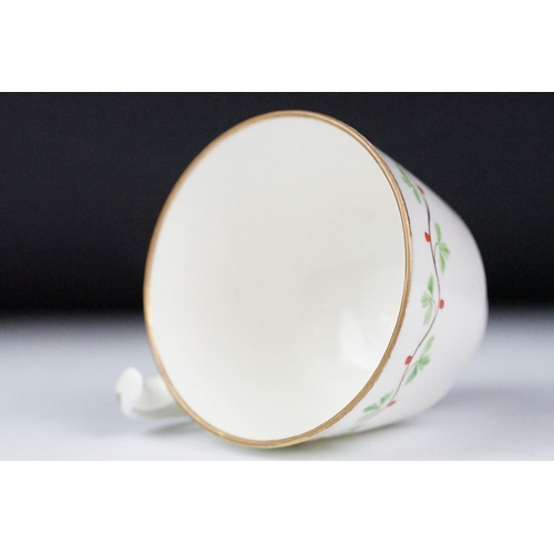 29 - Swansea pottery cup and saucer, hand painted with a floral garland, the saucer, 13.5cm diameter