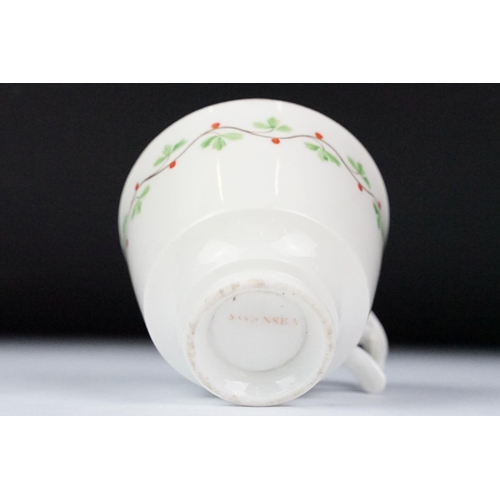 29 - Swansea pottery cup and saucer, hand painted with a floral garland, the saucer, 13.5cm diameter