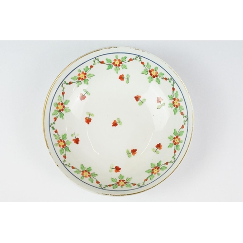 29 - Swansea pottery cup and saucer, hand painted with a floral garland, the saucer, 13.5cm diameter