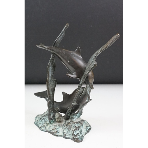 102 - Patinated bronze sculpture of two dolphins amongst sea grasses, 20cm high