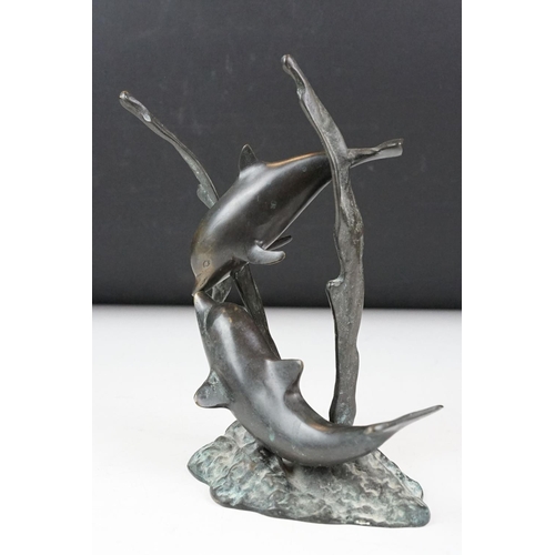 102 - Patinated bronze sculpture of two dolphins amongst sea grasses, 20cm high