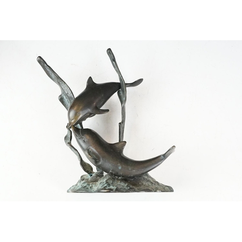 102 - Patinated bronze sculpture of two dolphins amongst sea grasses, 20cm high