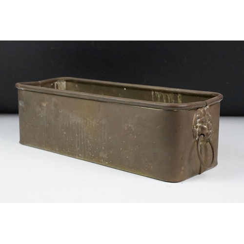 108 - Copper planter of rectangular form, with twin lion mask handles and rolled upper rim. Measures appro... 