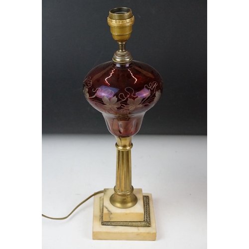 121 - Red flash glass table lamp with grape vine decoration, raised on a stepped glass base, together with... 