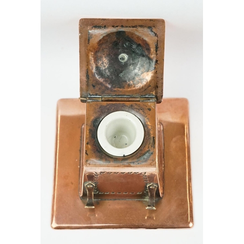 197 - Arts and Crafts Copper Square Inkwell, the hinged lid opening to a ceramic inkwell, pen hooks to sid... 