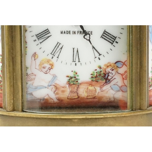 202 - An antique French miniature carriage clock, brass cased with beveled glass panels, decorative Cherub... 