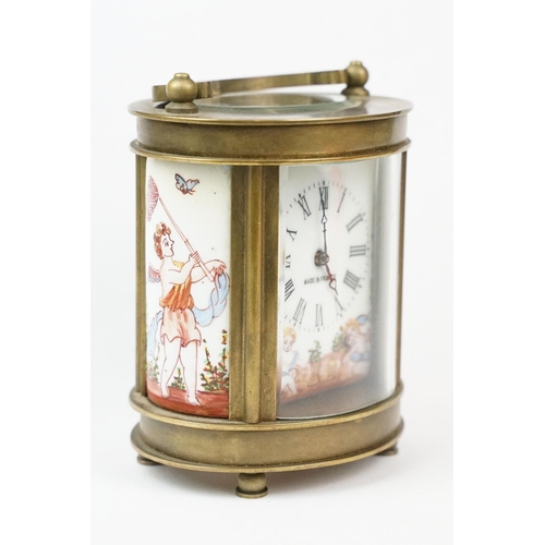 202 - An antique French miniature carriage clock, brass cased with beveled glass panels, decorative Cherub... 