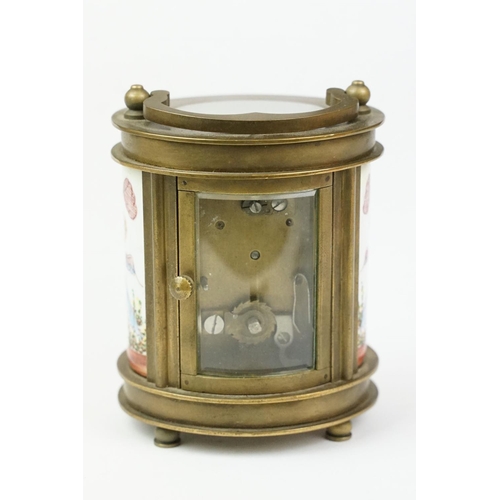 202 - An antique French miniature carriage clock, brass cased with beveled glass panels, decorative Cherub... 