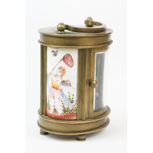 202 - An antique French miniature carriage clock, brass cased with beveled glass panels, decorative Cherub... 