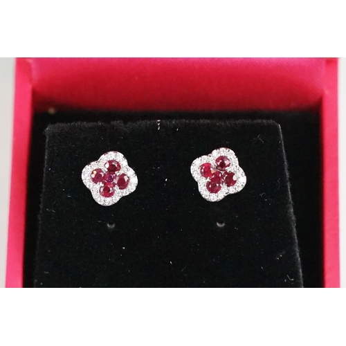 242 - Pair of 18ct white gold ruby and diamond clover leaf style stud earrings