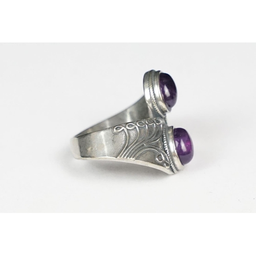 249 - A ladies silver double amethyst cabochon dress ring, marked 925 to the inner shank.