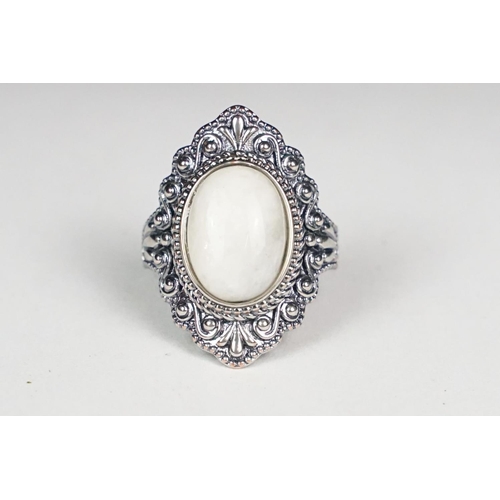 251 - A ladies silver moonstone cabochon dress ring, marked 925 to the inner shank.