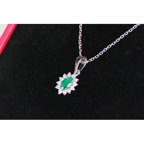 253 - 18ct white gold emerald and diamond pendant necklace