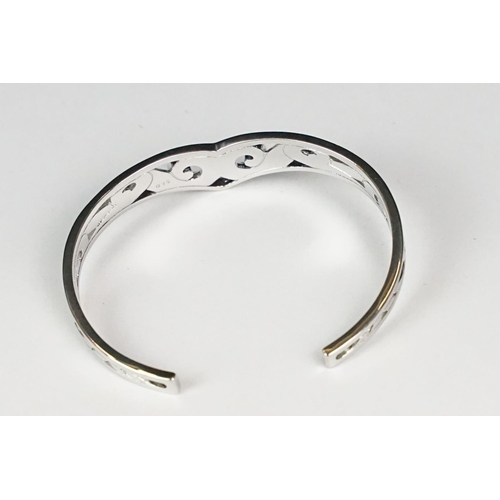 267 - A ladies silver open ended celtic bangle, marked 925 to the verso.