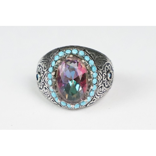 275 - A ladies silver dress ring with large central stone surrounded by turquoise, marked 925 to the inner... 