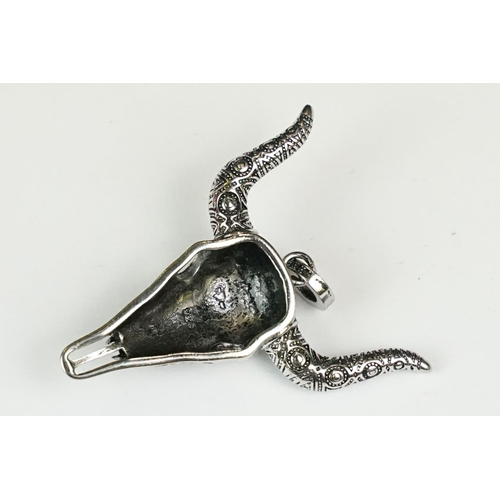 277 - A large silver pendant in the form of a bull's skull set with blue cabochons, marked 925 to the vers... 