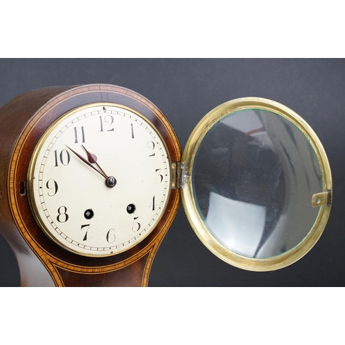 135 - Early 20th century inlaid mahogany balloon form mantel clock, raised on four gilt metal bracket feet... 