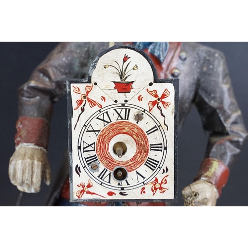 146 - Dutch painted cast metal novelty clock in the form of a clock peddler, approx 38cm high