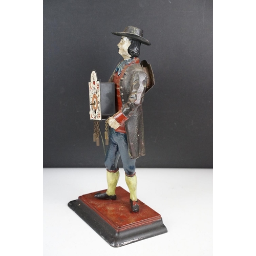 146 - Dutch painted cast metal novelty clock in the form of a clock peddler, approx 38cm high