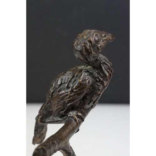 147 - Graham High - A bronze sculpture of a bird perched on a branch, raised on a rectangular base, signed... 