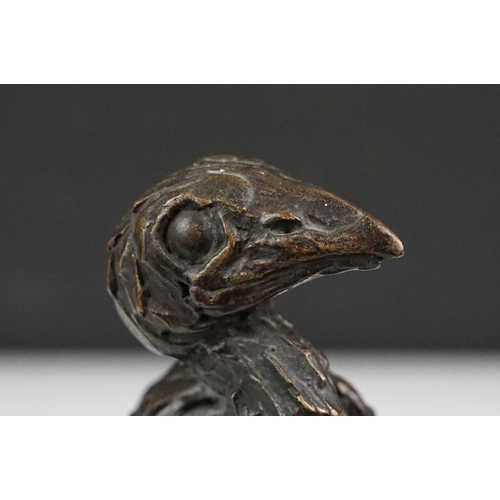 147 - Graham High - A bronze sculpture of a bird perched on a branch, raised on a rectangular base, signed... 