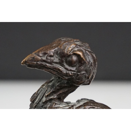 147 - Graham High - A bronze sculpture of a bird perched on a branch, raised on a rectangular base, signed... 