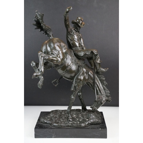 148 - Bronze figure of a rodeo rider on a marble base after Frederic Remington, height approx 48cm