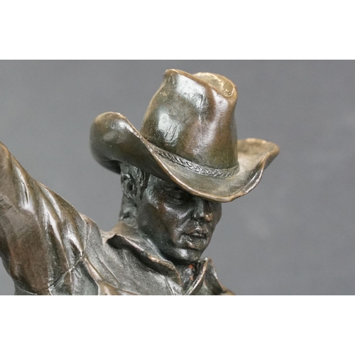 148 - Bronze figure of a rodeo rider on a marble base after Frederic Remington, height approx 48cm