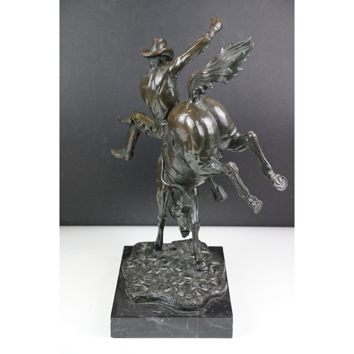 148 - Bronze figure of a rodeo rider on a marble base after Frederic Remington, height approx 48cm