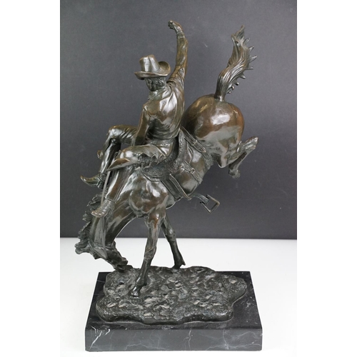 148 - Bronze figure of a rodeo rider on a marble base after Frederic Remington, height approx 48cm