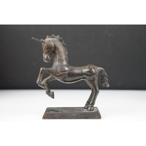 149 - Bronze figure of a leaping unicorn, together with a carved hardwood model of a rearing horse (approx... 