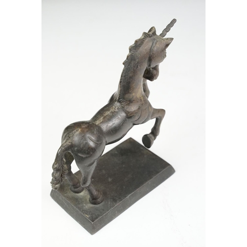 149 - Bronze figure of a leaping unicorn, together with a carved hardwood model of a rearing horse (approx... 