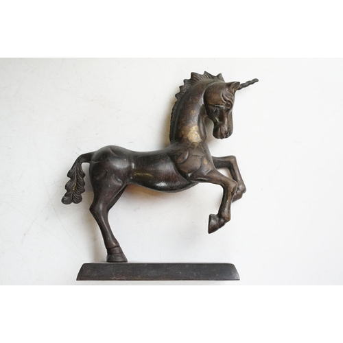 149 - Bronze figure of a leaping unicorn, together with a carved hardwood model of a rearing horse (approx... 