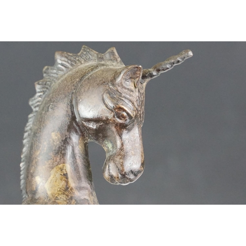 149 - Bronze figure of a leaping unicorn, together with a carved hardwood model of a rearing horse (approx... 