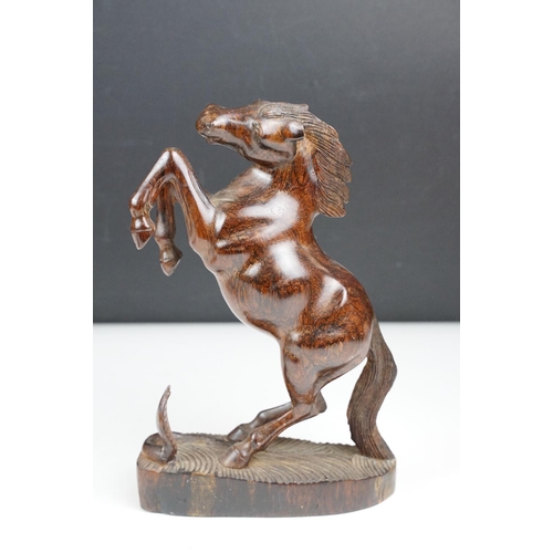 149 - Bronze figure of a leaping unicorn, together with a carved hardwood model of a rearing horse (approx... 