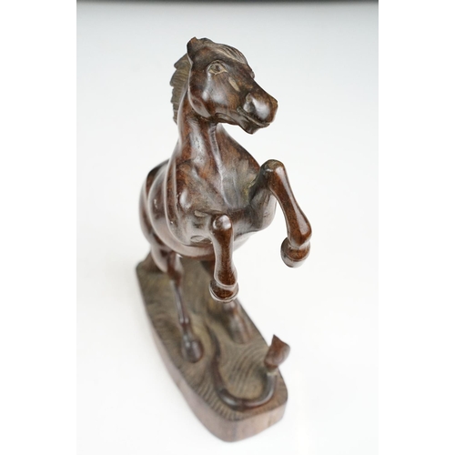 149 - Bronze figure of a leaping unicorn, together with a carved hardwood model of a rearing horse (approx... 