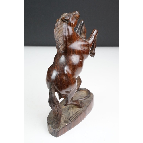 149 - Bronze figure of a leaping unicorn, together with a carved hardwood model of a rearing horse (approx... 