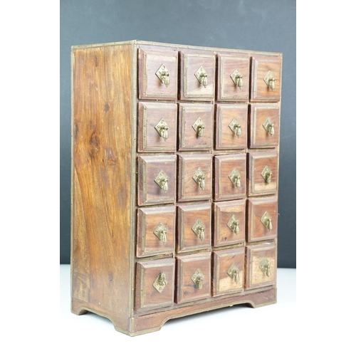 151 - Indian wooden table top cabinet / spice cabinet, the twenty drawers with brass handles and brass dec... 