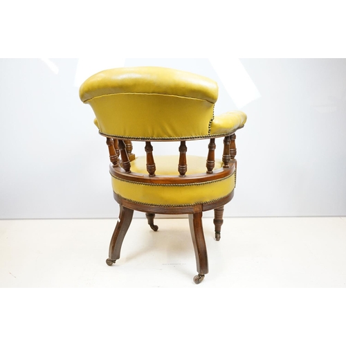 656 - Edwardian mahogany tub shaped armchair, with studded green leatherette button back above galleried b... 