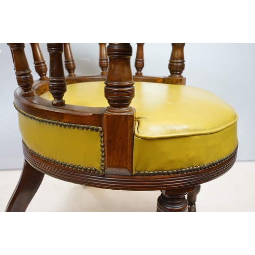 656 - Edwardian mahogany tub shaped armchair, with studded green leatherette button back above galleried b... 