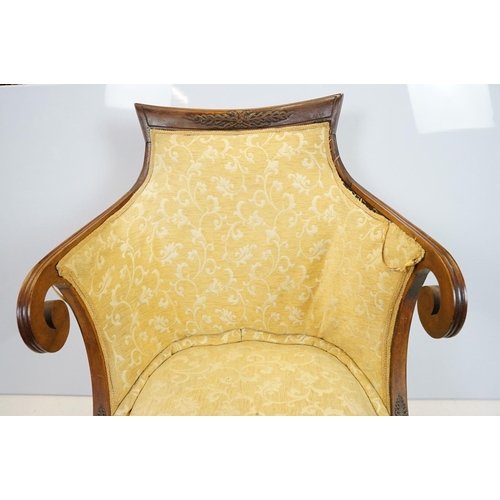 657 - Empire style mahogany chair, with carved top rail above scroll arms with carved motif on sabre legs,... 