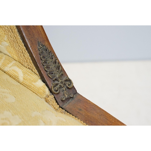 657 - Empire style mahogany chair, with carved top rail above scroll arms with carved motif on sabre legs,... 