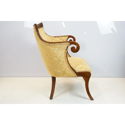 657 - Empire style mahogany chair, with carved top rail above scroll arms with carved motif on sabre legs,... 