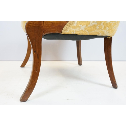 657 - Empire style mahogany chair, with carved top rail above scroll arms with carved motif on sabre legs,... 