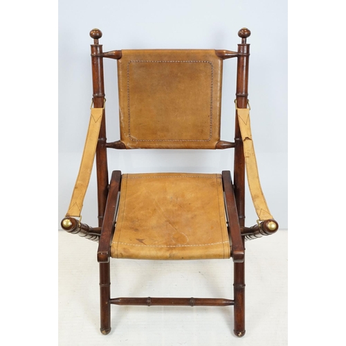 659 - 20th century mahogany campaign style chair, the frame carved to simulate bamboo with tan leather, se... 