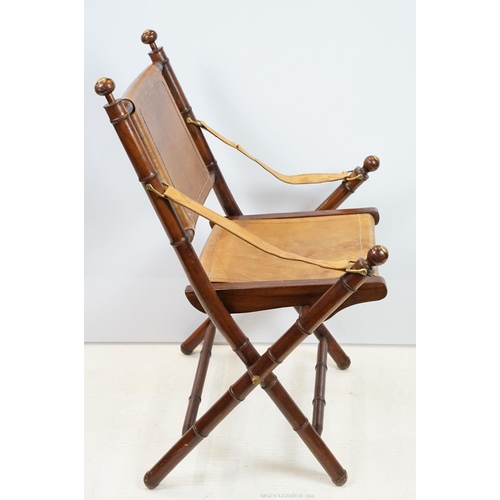 659 - 20th century mahogany campaign style chair, the frame carved to simulate bamboo with tan leather, se... 