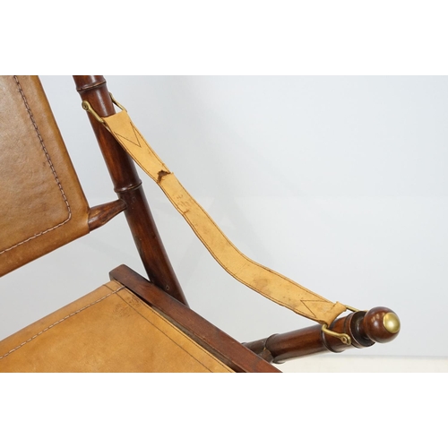 659 - 20th century mahogany campaign style chair, the frame carved to simulate bamboo with tan leather, se... 