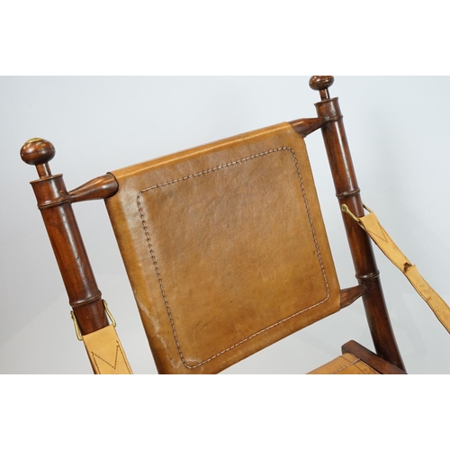 659 - 20th century mahogany campaign style chair, the frame carved to simulate bamboo with tan leather, se... 