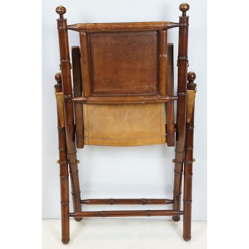 659 - 20th century mahogany campaign style chair, the frame carved to simulate bamboo with tan leather, se... 